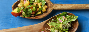 Two salads in wooden spoons